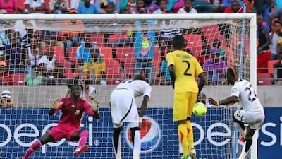 Ghana's Mubarak Wakaso, right, scores the only goal of the match. Schalk van Zuydam / AP Photo