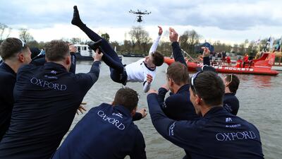 Jack Tottem, the University of Oxford team's coxswain, is thrown into the River Thames after victory over rivals Cambridge in the Gemini Boat Race in London. Getty Images