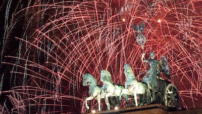 Fireworks explode over the Brandenburg Gate at midnight on New Year's Day, January 01, 2024 in Berlin, Germany. Getty Images