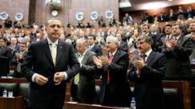 Tayyip Erdogan, Turkey's prime minister, leaves his seat to address members of parliament in Ankara.