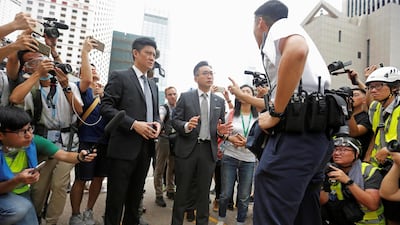 Lawmakers Jeremy Tam and Alvin Yeung of the Hong Kong Civic Party speak to a police officer. Reuters