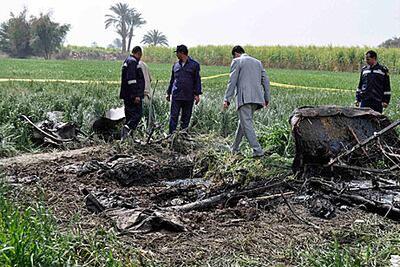 Egyptian rescuers search through the wreckage of a hot air balloon that crashed west of Luxor.