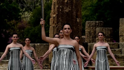 Actress Mary Mina, playing the role of the High Priestess, holds the torch during the Paris 2024 flame lighting ceremony in Olympia, Greece. Getty Images