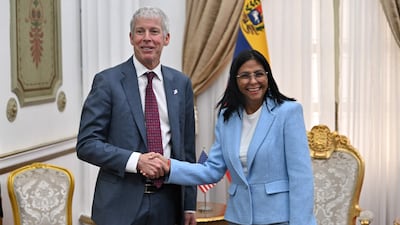 US Energy Secretary Chris Wright shakes hands with Venezuelan interim president Delcy Rodriguez in Caracas. AFP