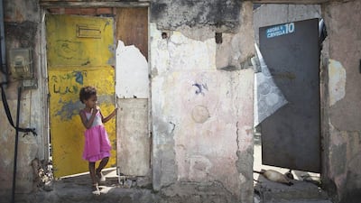 A child stands at the entrance to her house on the same street where Brazilian judo gold medalist Rafaela Silva used to live in the Cidade de Deus slum of Rio de Janeiro, Brazil, on August 9, 2016. Leo Correa/AP Photo