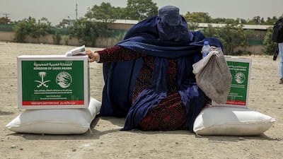 A woman receives food rations in Kabul, Afghanistan. EPA