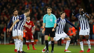 West Bromwich Albion players remonstrate with referee Craig Pawson after he asks for VAR (Video Assistant Referee) after a challenge by West Brom's Jake Livermore on Liverpool's Mohamed Salah before awarding a penalty. Phil Noble / Reuters