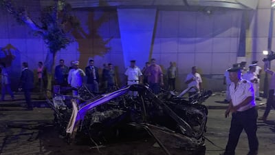 People look on at the damage left by a fire from a blast outside the National Cancer Institute, Cairo, Egypt. EPA