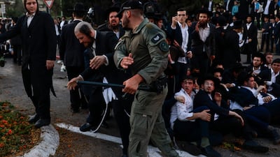 Israeli police use batons to disperse ultra-Orthodox Jews as they protest against their military conscription in Israel and the arrest of religious school students who avoided draft orders, at a rally in Jerusalem. AFP