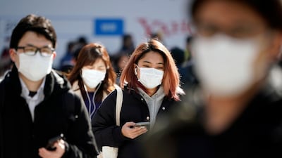 Pedestrians wearing masks cross a street in Shibuya district, Tokyo, Japan. EPA