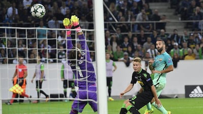 Barcelona’s Arda Turan, right, scores his side’s opening goal during the Champions League match against Borussia Monchengladbach. Martin Meissner / AP Photo