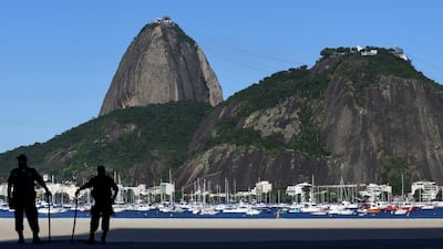 Police officers patrol the Botafogo beach following the closure of the beaches, amid the coronavirus disease (COVID-19) outbreak, in Rio de Janeiro, Brazil. REUTERS