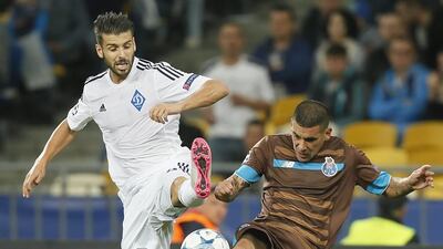 FC Porto's Maxi Pereira challenges for the ball with Miguel Veloso of Dynamo Kiev during their draw in Champions League group play on Wednesday night. Sergey Dolzhenko / EPA