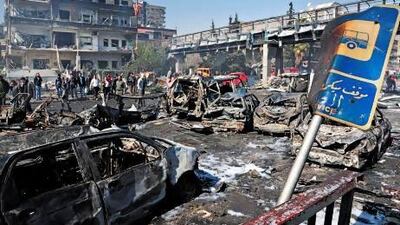 Syrians inspect the scene following a powerful car bomb explosion near the headquarters of Syria's ruling Baath party in the centre of Damascus on Thursday.