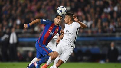 Barcelona striker Luis Suarez takes on Paris Saint-Germain defender Marquinhos. Laurence Griffiths / Getty Images