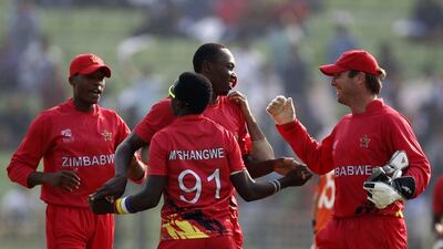 Zimbabwe cricketers celebrate after the dismissal of unseen Netherlands batsman Michael Swart during the ICC T20 World Cup qualifying match between the Netherlands v Zimbabwe at Sylhet International Cricket Stadium in Sylhet on March 19, 2014. AFP PHOTO/STR