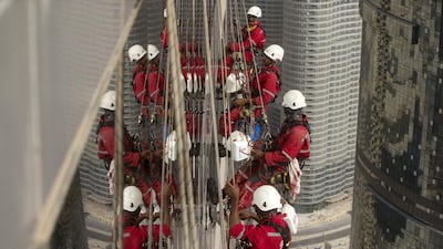 When given the signal, the workers start their slow decent, washing off a few weeks of dust and dirt, one window at a time. Christopher Pike / The National