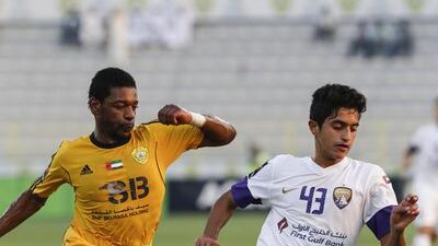 Al Ain's Ryan Mohamad, right, turns away from Ganim Ahmed Basheer during their Arabian Gulf League match in Dubai on May 9, 2014. Antonie Robertson / The National