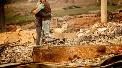 Chris and Nancy Brown embrace while searching through the remains of their home, leveled by the Camp Fire, in Paradise. AP Photo