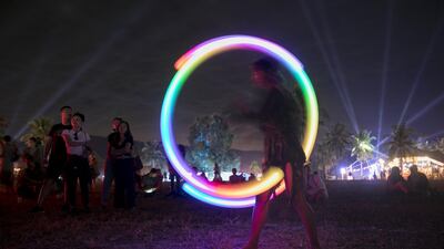 A woman performs a light show during Wonderfruit 2018 in Pattaya, Thailand. Getty Images