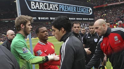 Luis Suarez refuses to shake the hand of Patrice Evra of Manchester United ahead of a Premier League football match at Old Trafford, Manchester, England, in February, 2012. John Peters / Getty Images