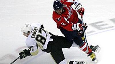 The Capitals' Alex Ovechkin sends Pittsburgh's Sydney Crosby crashing to the ice.