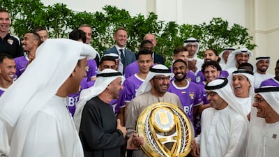 Sheikh Mohamed, Sheikh Hazza bin Zayed, Ruler's Representative in Al Ain Region, and Dr Sultan Al Jaber, Minister of Industry and Advanced Technology and managing director and group chief executive of Adnoc, with the league trophy