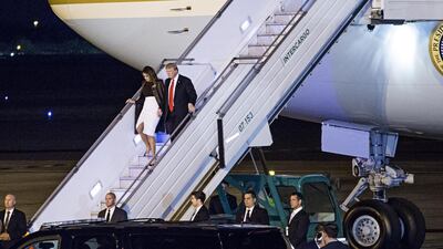 President Donald Trump, right, and U.S. First Lady Melania Trump disembark from Air Force One after arriving at Ezeiza Airport ahead of the G-20 Leaders' Summit in Buenos Aires, Argentina. Bloomberg