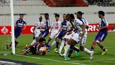 Al Ain's goalkeeper Dawoud Sulaiman stops an attempt by Sharjah.