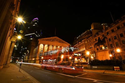 An empty bus is driven through the quiet streets outside the Bank of England in the early hours, as lockdown continues in London. Reuters