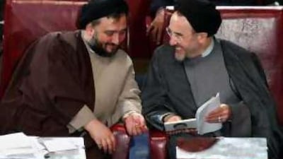 Mohammad Ali Abtahi, left, a former vice president of Iran and chief of staff for then-president Mohammad Khatami, shares a light moment with Mr Khatami during an open session of parliament in Tehran in April 2004.