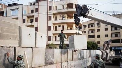Egyptian army engineers and soldiers reinforce a concrete wall around the presidential palace in Cairo. Clashes outside the palace between Islamists and opposition supporters continue.
