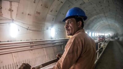 A labourer stands at the construction site. AFP