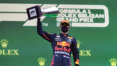 Red Bull's Max Verstappen celebrates on the podium after taking first place in the rain-ravaged Belgian Grand Prix at the Spa-Francorchamps circuit on Sunday, August 29. AFP