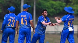 UAE's Aayan Khan, second right, picked up five wickets against Oman. Photo: ACC