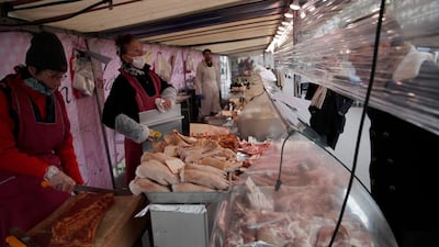 Vendors have installed plastic protection separating themselves from their customers in a street market in Paris, on March 21, 2020. AP Photo