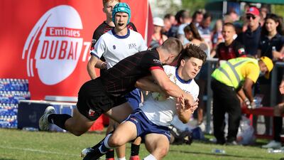 Players in action during the Gulf Under 19 boys cup semi-final 2 match between Dubai English Speaking College (black) vs Jumeirah English Speaking School (white and blue).