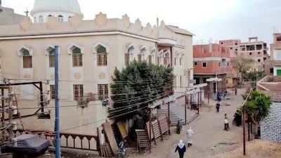 People make their way past Sharqi mosque as Sheikh Muhammad Raslan gives a sermon this month. Shawn Baldwin for The National