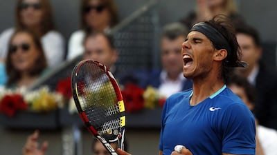 Rafael Nadal of Spain celebrates winning a point to Kei Nishikori of Japan during their men's singles final match at the Madrid Open tennis tournament on May 11, 2014. REUTERS/Susana Vera