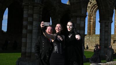 'Vampires' pose for a selfie on the grounds of Whitby Abbey. AFP