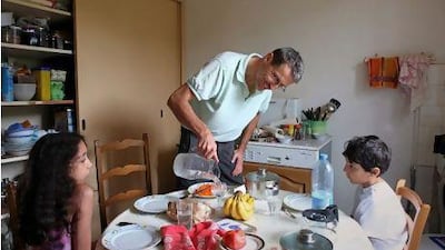 Dany Laurent prepares lunch for his children Diane, 12, and Etienne, 10, at their home in Besancon, France. It has taken him six years, countless trips to Iran and a conversion to Islam to regain custody of them.