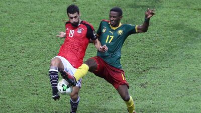 Egypt forward Abdallah Said, left, vies for the ball against Cameroon midfielder Arnaud Sutchuin-Djoum. Steve Jordan / AFP