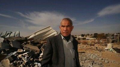 Nuri Al Okbi next to his nephew's demolished house in Hirbat Khurah village.