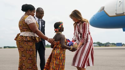 Melania Trump accepts flowers from flower girl Lillian Naa Adai Sai, 8, at Kotoka International Airport in Accra, Ghana. AP Photo