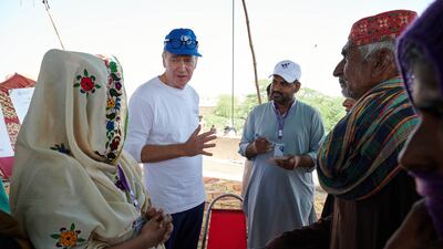 Chris Kaye, second left, at an aid distribution point after severe flooding swamped the Sindh Province of Pakistan. Photo: World Food Programme