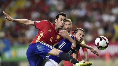 Spain midfielder Sergio Busquets, left, duels for the ball with Liechtenstein’s Sandro Wieser. Alvaro Barrientos / AP Photo