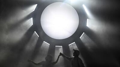 Visitors pose for pictures with light installations at SangSom Moonlab, an interactive art exhibition in Bangkok. AFP