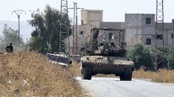 Israeli forces patrol a village as they conduct raids in residential areas and fire harassment shots at open areas in the countryside of Quneitra, southern Syria. Getty Images