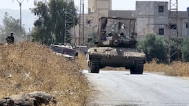 Israeli forces patrol a village as they conduct raids in residential areas and fire harassment shots at open areas in the countryside of Quneitra, southern Syria. Getty Images