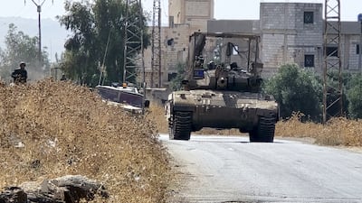 Israeli forces patrol a village as they conduct raids in residential areas and fire harassment shots at open areas in the countryside of Quneitra, southern Syria. Getty Images